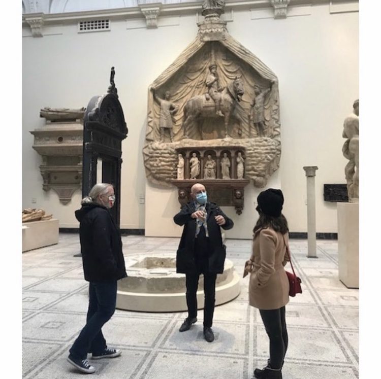 A group is observing a statue.