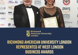 Two people are posing with an award certificate at an event, likely a business awards ceremony, with multiple logos and event information in the background.